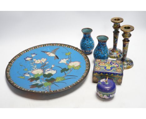Seven Chinese or Japanese cloisonné enamel items including a pair of candlesticks, 15cm high, a charger, two boxes and a pair