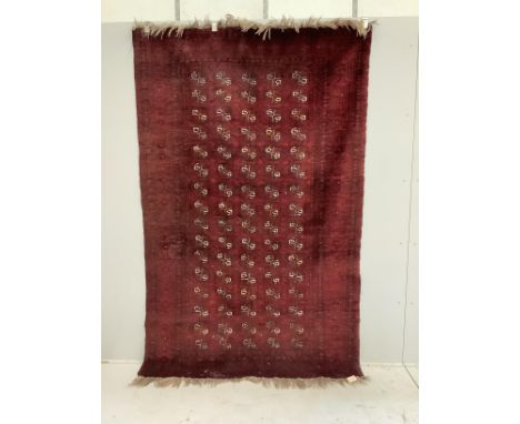 A Bokhara red ground carpet, 240 x 156cm