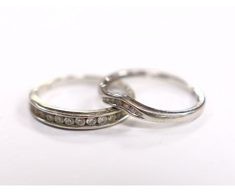 A modern 9ct white gold and diamond chip set half eternity ring, size M and a similar 9ct gold part curved channel set diamon