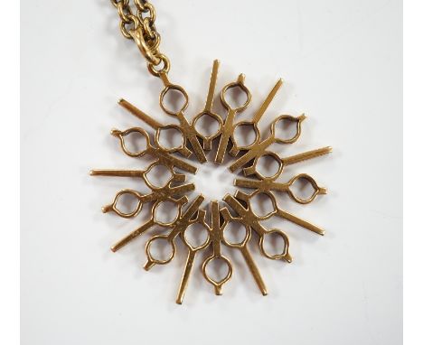 A yellow metal pendant, 37mm, on a 375 chain, 52cm, gross weight 17.8 grams.
