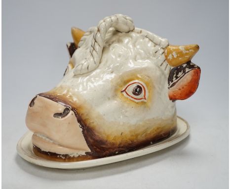 A Victorian ‘cows head’ pottery cheese dish and cover, 18cm Two small cracks visible at interior, not serious; considerable f