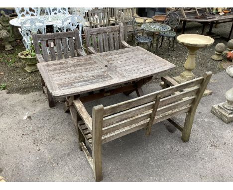 A rectangular weathered teak garden table, width 152cm, depth 86cm, height 74cm, together with a teak garden bench and two ar