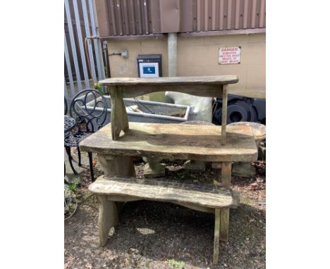 A rustic style rectangular elm garden table, width 122cm, depth 54cm, height 68cm together with a pair of bench seats