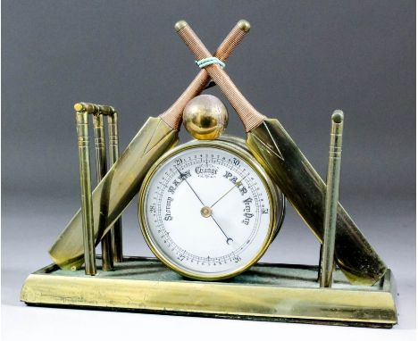 A late Victorian gilt brass cased desk aneroid barometer of cricketing interest, the 3.5ins diameter white enamel dial, conta