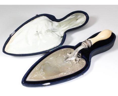 A Victorian silver presentation trowel with turned ivory and cast silver handle, the blade engraved with strap work ornament,