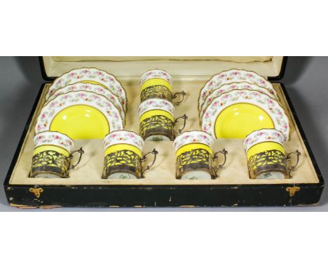 A set of six early 20th Century Aynsley bone china coffee cups and saucers, printed and painted with a flowering garland to r