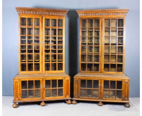 A pair of modern oak "Pepys" bookcases, each with deep moulded cornice carved with leafage and gadrooning, the upper part eac