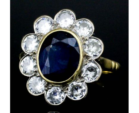 An 18ct gold mounted sapphire and diamond ring, set with central oval cut diamond (approximately 2ct) surrounded by ten brill