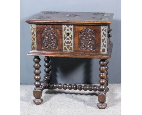 A 19th Century oak and steel bound rectangular bible box of "17th Century" design, the top, front and sides carved with panel