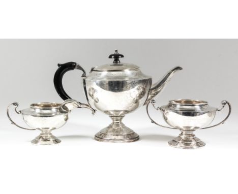 A George V silver circular three-piece tea service with C-scroll handles, on circular stepped footrim, comprising - teapot wi