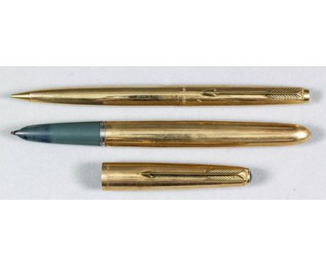 A Parker gilt metal cased fountain pen with engine turned ornament, and matching propelling pencil, and a small selection of 