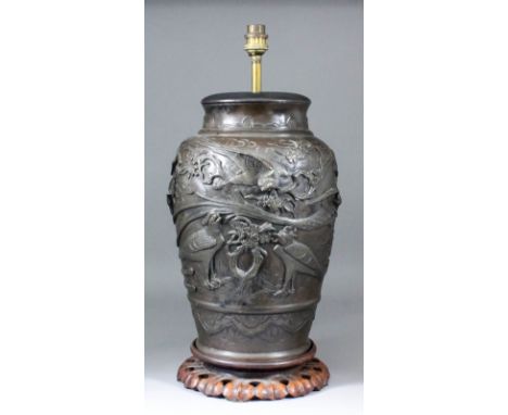 A Japanese brown patinated bronze vase, cast with exotic birds amongst rock work and blossoms, 13.5ins (34.3cm) high, with se