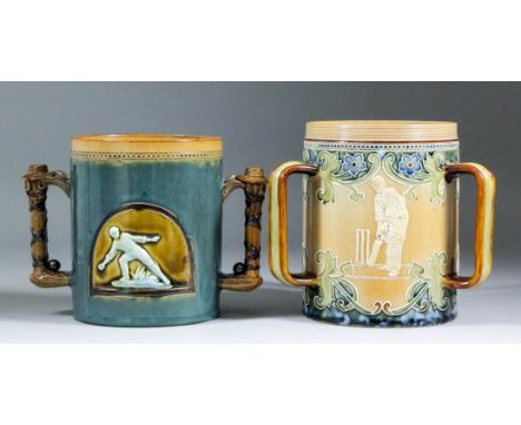 A late 19th Century Doulton Lambeth stoneware three-handled tyg moulded in relief with three cricketers within leaf borders, 