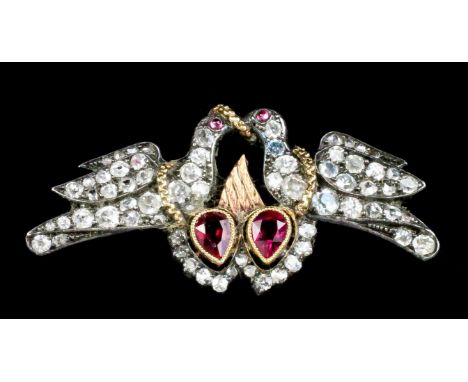 A 19th Century silvery and gold coloured metal mounted diamond and ruby brooch in the form of two kissing lovebirds perched o