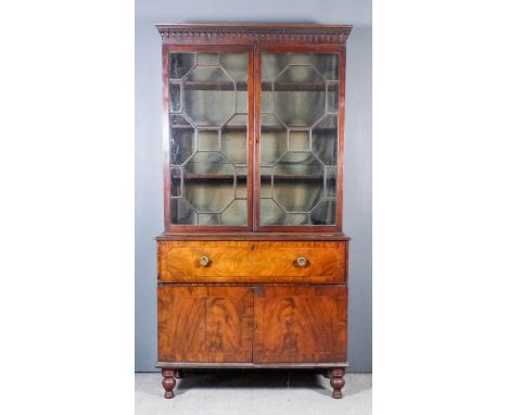 A George III mahogany secretaire bookcase, the upper part with moulded cornice, dentil and pendant pattern frieze, fitted thr