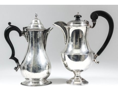 A George V silver baluster shaped hot water pot with gadroon mounts, the domed cover with spiral reeded finial and ebonised d