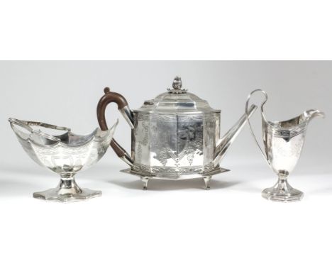 A George III silver octagonal four-piece tea service with reeded mounts, engraved with vacant shield shaped cartouche, floral