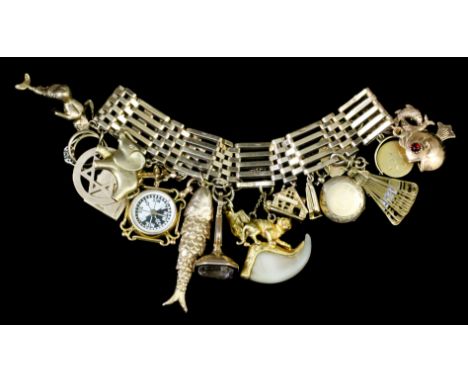 A modern 9ct gold five gate bracelet with heart pattern padlock clasp, hung with sixteen various charms (gross weight 85 gram