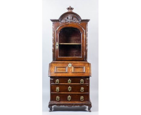 A Dutch oak miniature bureau cabinet of "18th Century" design, the upper part with shaped and moulded top surmounted by crown