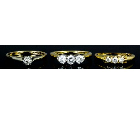 An 18ct gold mounted three stone diamond ring, set with brilliant cut diamonds (each approximately .15ct), (size M+ - gross w