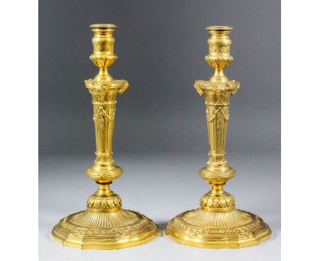 A pair of 19th Century French ormolu pillar candlestick of "Louis XVI" design, the columns crisply cast with three rams' head