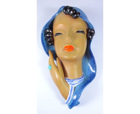 Goldscheider pottery wall mask, modelled as a lady in blue scarf with black curled hair, painted marks, H31.5cm   Condition R