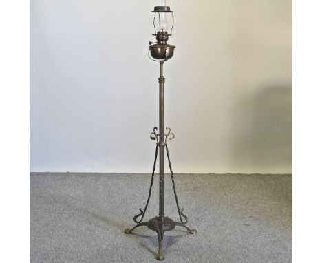 An early 20th century brass telescopic standard lamp and shade
