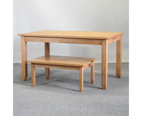 A modern light oak dining table, 150 x 90cm, together with a matching occasional table