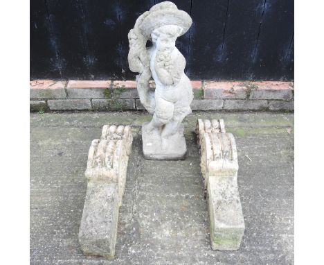 A pair of reconstituted stone architectural corbels, together with a garden statue, 69cm high