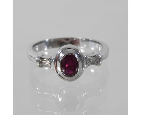 An 18 carat gold ruby and diamond dress ring, boxed, size K