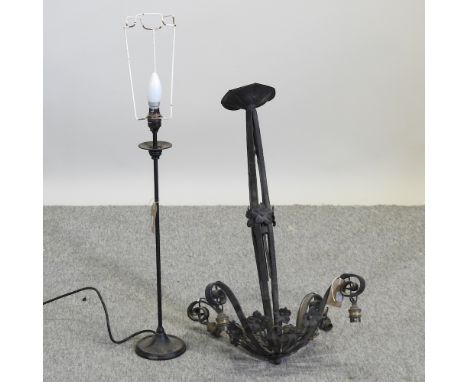 A black painted wrought iron ceiling light, with scrolled decoration, together with a similar table lamp (2)