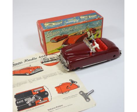 A Schuco vintage radio 4012, in the form of a toy car, 15cm long, boxed, with instructions and key