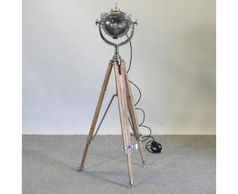 A chrome spotlight, on a teak tripod base,132cm high