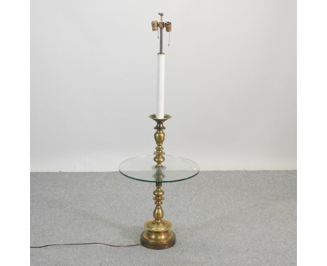 A cream painted standard lamp, with a circular glass shelf, 150cm high