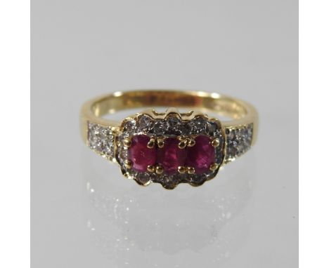 An 18 carat gold ruby and diamond ring, boxed, size L