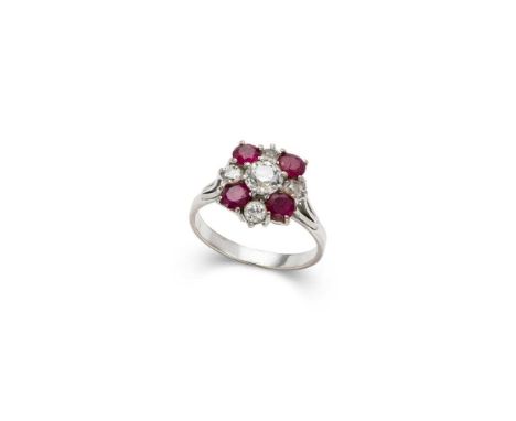 A ruby and diamond cluster ring claw-set with an old round-cut diamond in a border of graduated old round-cut diamonds and ru