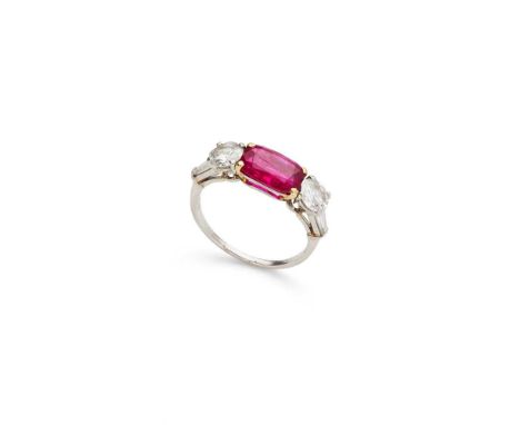 Bulgari: A ruby and diamond ring claw-set with a cushion-shaped ruby, between two round brilliant and tapered baguette-cut di