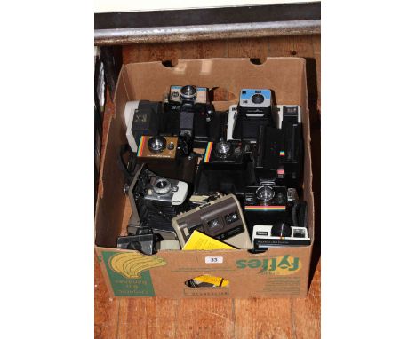 Box of Polaroid and vintage cameras.