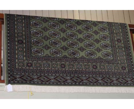 Bokhara carpet with a green ground 2.30 by 1.60.