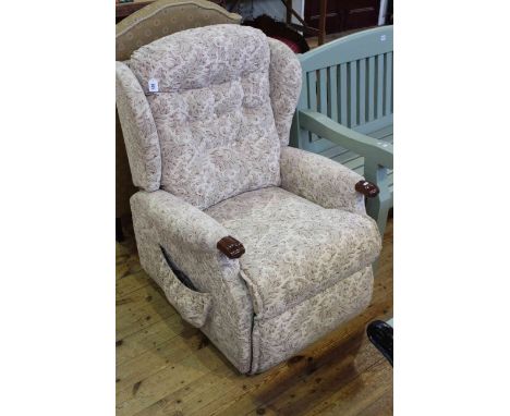 Sherborne rise and fall electric reclining chair in light foliate pattern fabric.