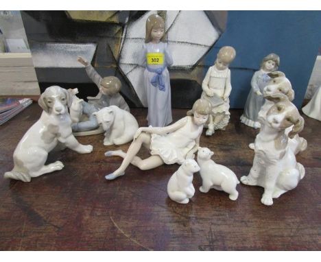 A group of Lladro and Nao porcelain figurines and animal models to include a boy playing with a dog (11) 