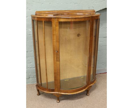 An early C20th walnut bow front china cabinet with etched glass decoration.