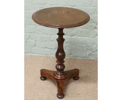 A Victorian mahogany side table with tripod base and turned supports.