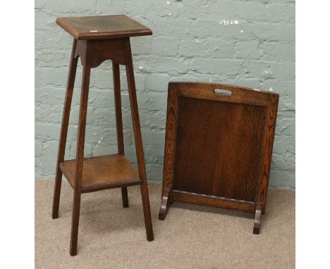 An Edwardian carved oak plantstand and oak fire screen.