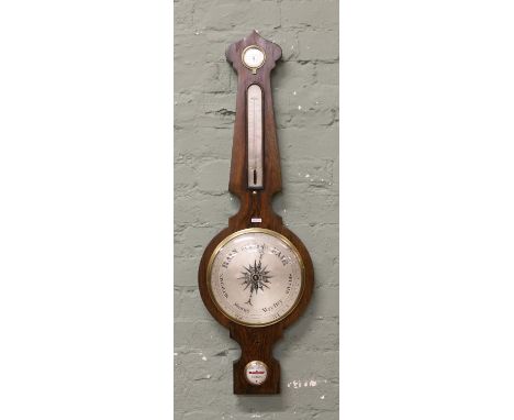 A Regency rosewood banjo barometer with silvered dials and aneroid conversion.