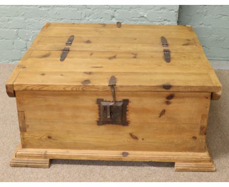 A large pine back to back coffer/coffee table with wrought iron hinges, iron locks and raised on bracket feet.