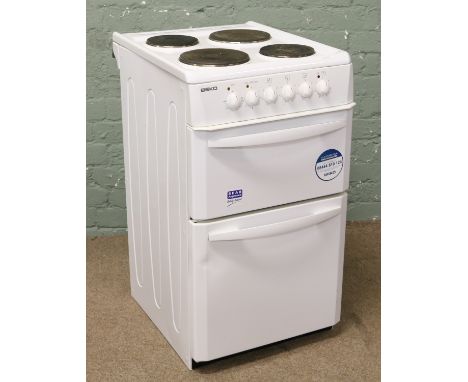 A Beko white enamel electric cooker.