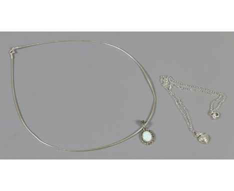 Two silver necklaces each with opal pendants, one with marcasites. 