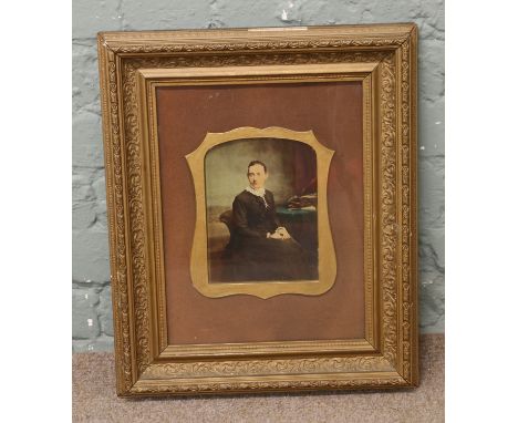 A gilt framed Victorian overpainted photograph, portrait of a seated woman. 