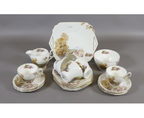 A Shelley heather pattern tea service comprising six cups and saucers, six side plates, tray and cream jug.